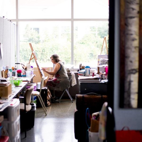 Lynn Frisinger Stribley paints in her studio space that she rents from the GVSU Muskegon Innovation Hub.