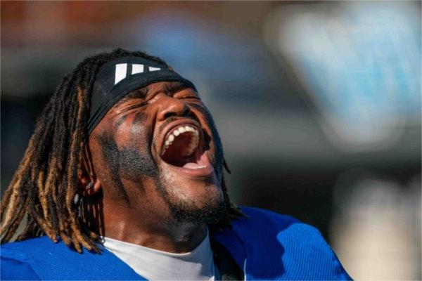  A football player yells while getting ready to begin a game.