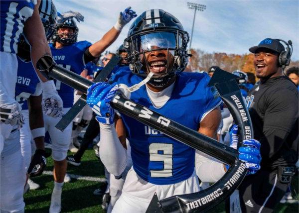  A member of the football team holds an anchor while celebrating a play.