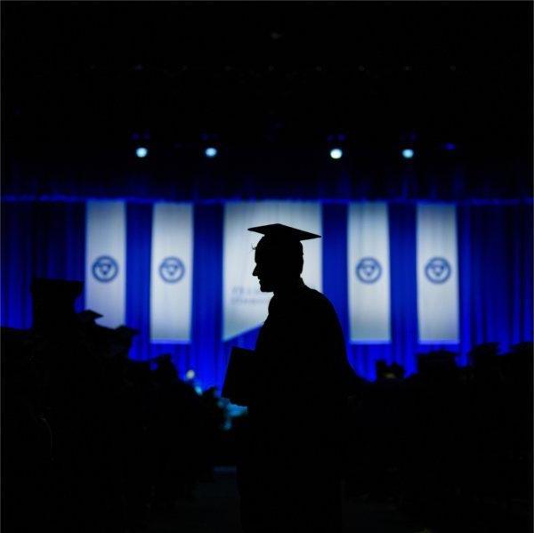 A member of the class of 2023 returns to his seat after getting his diploma.