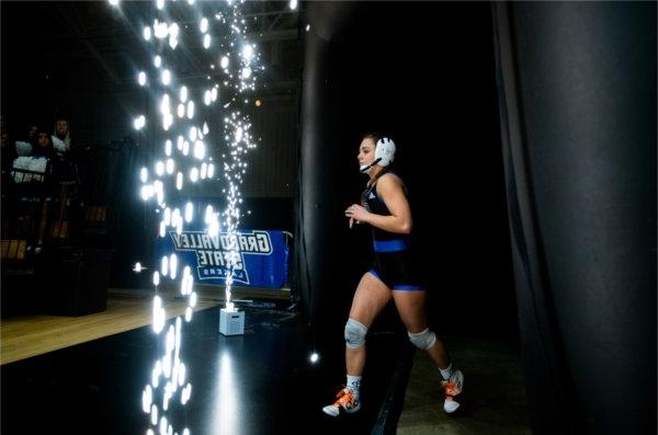 A GVSU wrestler emerges from the locker room for her match.