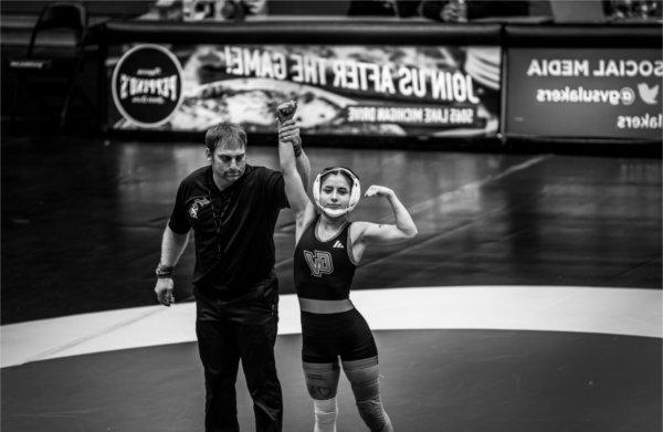 A GVSU wrestler celebrates her forfeit win.