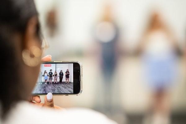 A person holds a phone recording a video.