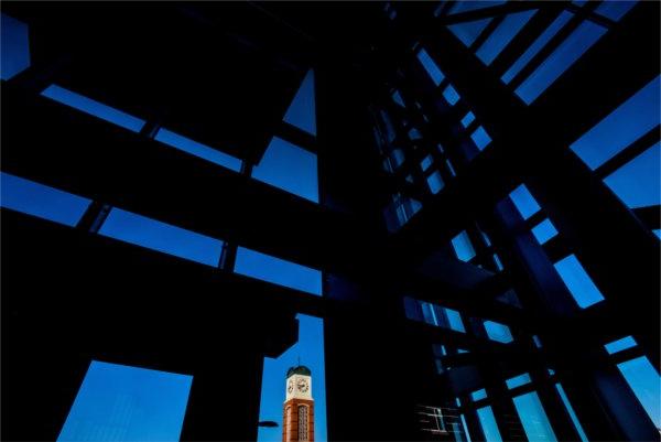 A carillon tower is seen through the windows of the Kirkhof Center. 