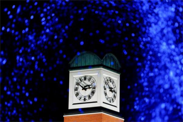 The Cook Carillon Tower is pictured through the blue lights of the Zumberge Pond fountain.