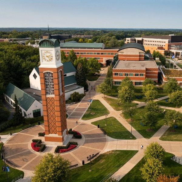 Drone photo of Allendale campus with clock tower at center and lots of sidewalks