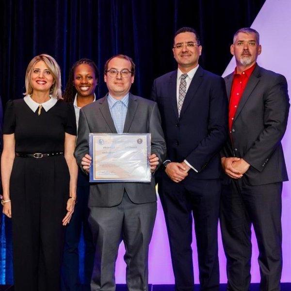 Representatives from the College of Computing accept the cybersecurity designation during national conference.