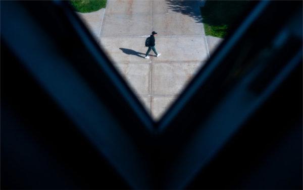  A triangular-shaped window created a v-shape where a student walks past. 