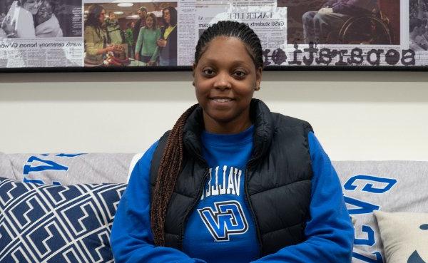 Kaiya Smith sits on a coach in the Office of Multicultural Affairs, she is wearing a blue sweatshirt and black vest